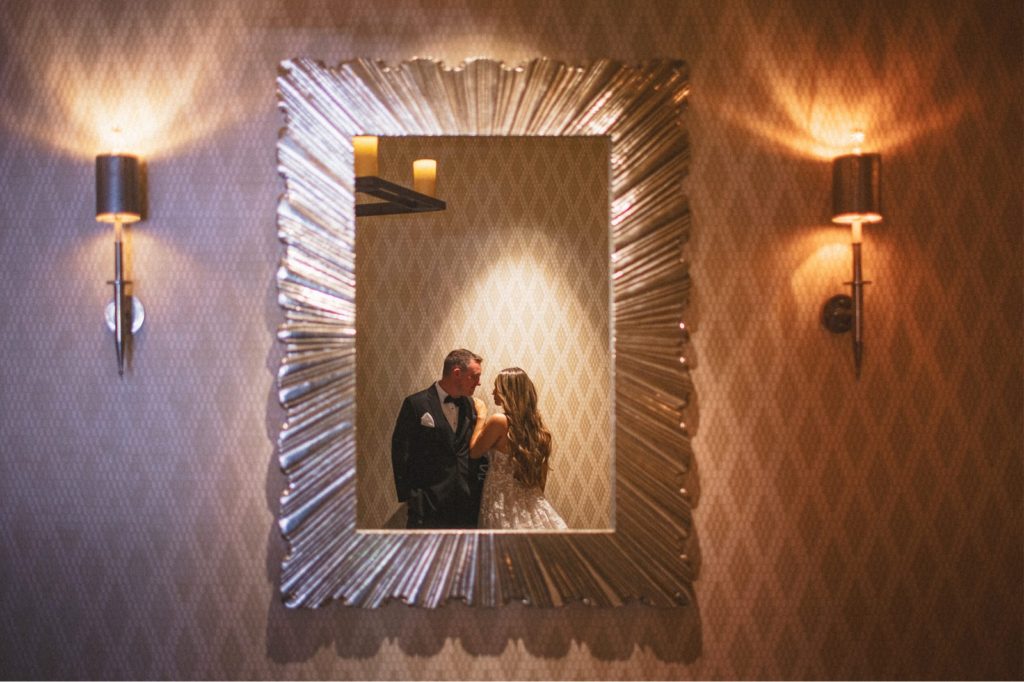 The Sinclair venue San Diego creative couples portrait taken through the mirror or couple close and intimate with each other