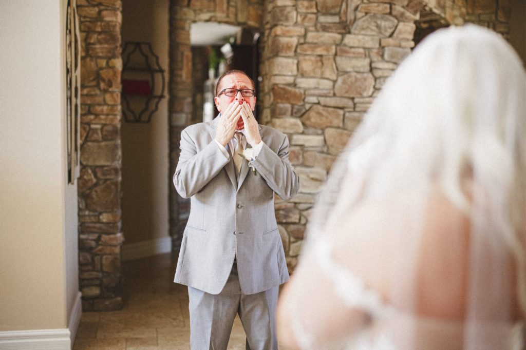 Dad seeing his daughter for the first time in her dress and cry and being emotional