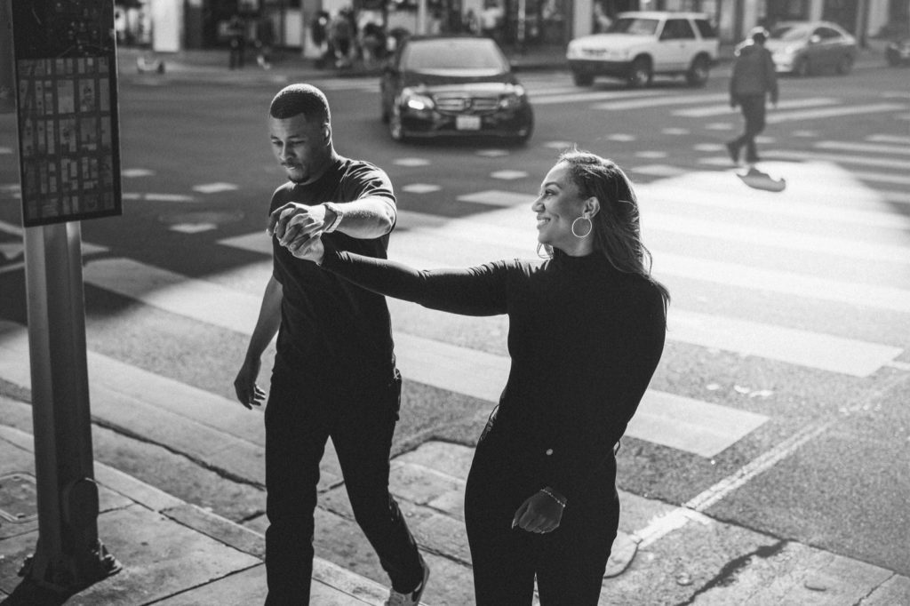 Down town LA Engagement session of couple crossing the street taken by Santa Barbara Wedding photographer Montana Dennis