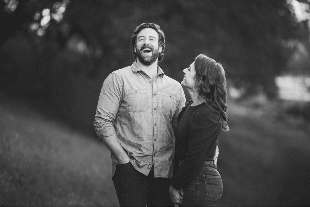 Candid black and white photo of couple laughing taken by Wedding Photographer Montana Dennis