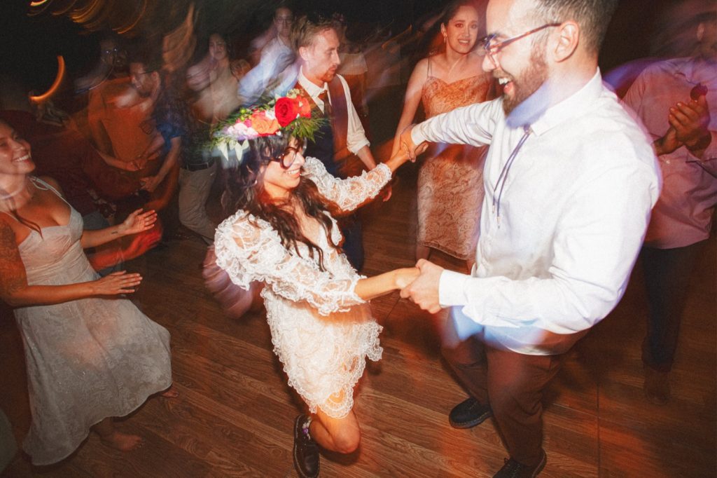 Cielo Farms wedding reception fun and candid photo of couple on the dance floor having fun and holding hands