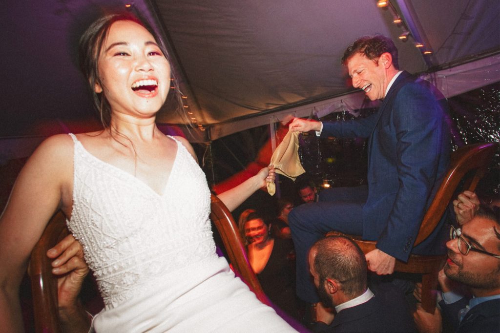 Couple at their reception being held up on chairs at their wedding in Montecito 